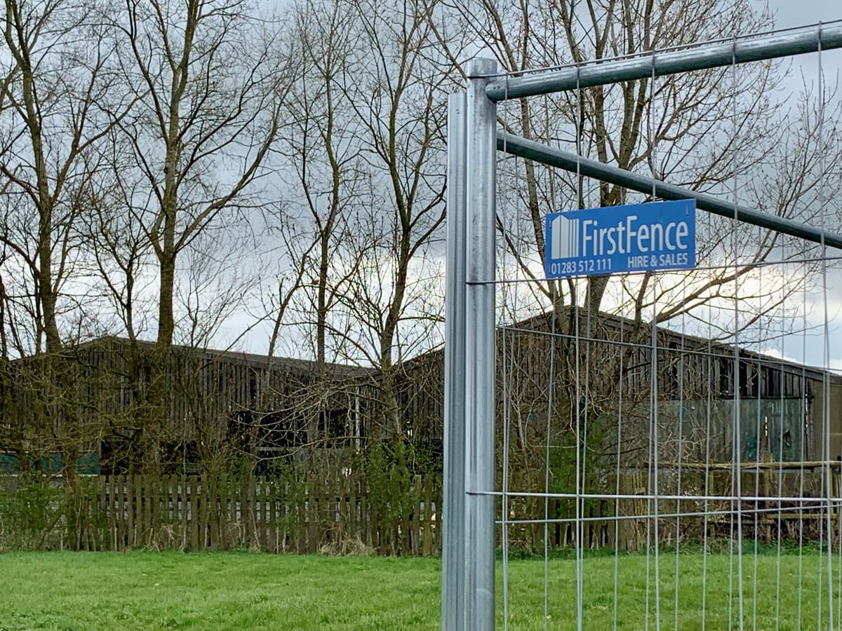 Temporary fencing panel with the First Fence logo