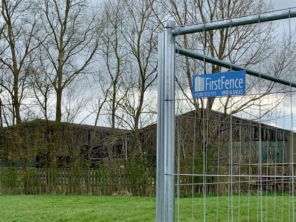 Temporary fencing with the First Fence Logo on
