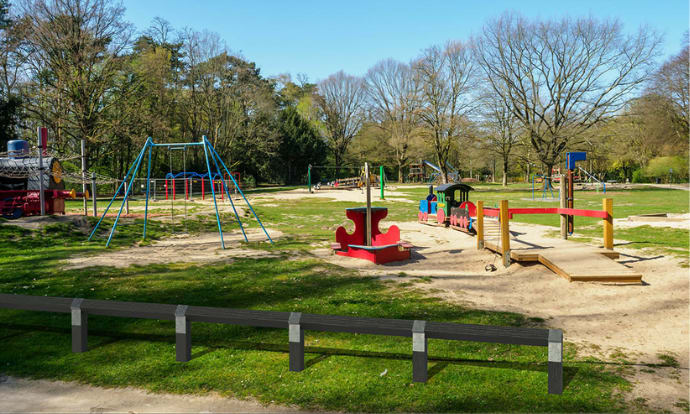 Recycled plastic knee rail fencing near a playground