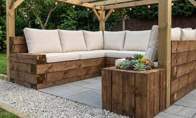 Creosoted railway sleepers used to create outdoor furniture and a flower box