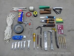 A selection of tools to break into fencing. This includes WD 40, rope, tape, spanners, and screwdrivers