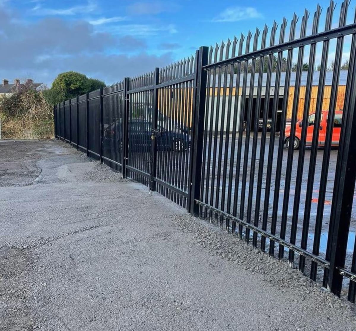 Black Palisade Fencing Around an Industrial Site
