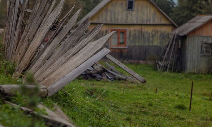 Collapsed timber picket fence