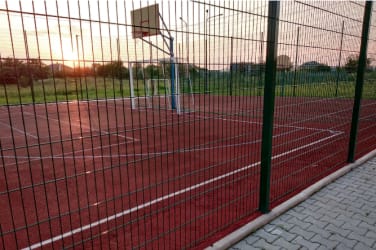 Sports court with wire mesh fencing 