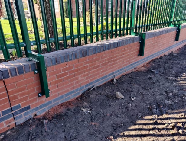 Cranked posts installed on concrete wall