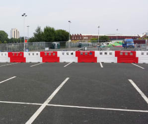 Row of white and red water filled barriers