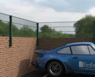 First Fence mesh wall topper installed on a brick wall, with a blue car parked nearby