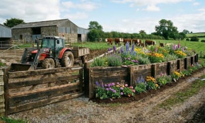 Railway sleepers used to create a flower bed at a farm