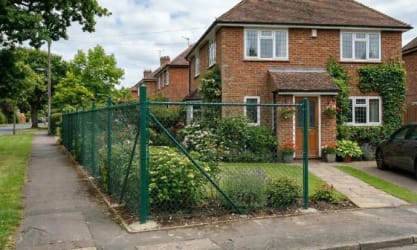 Chain link fencing installed outside a home