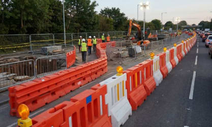 Construction site on a main road with various safety barriers in place