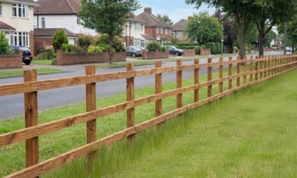 Highway timber post and rail fencing installed at a roadside