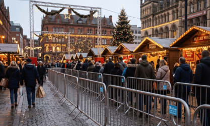Christmas market in the UK with crowd control barriers to help foot traffic flow through the stalls