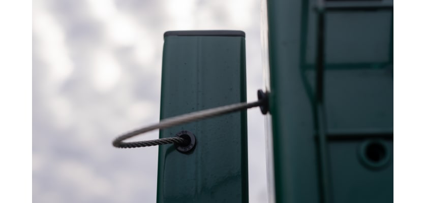 Close up of gatemaster restainer installed on mesh gate 