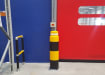 Yellow and Black bollard protecting an area of a warehouse