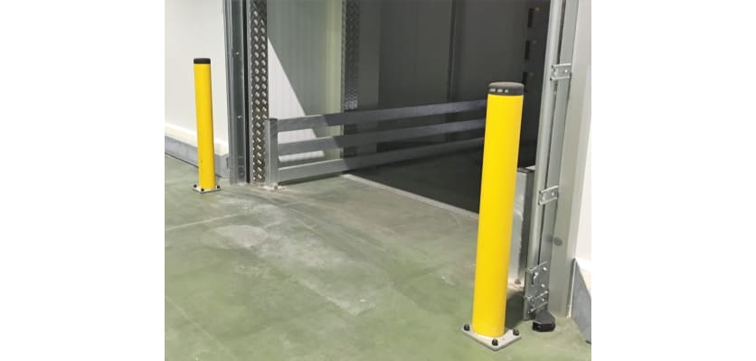 Two high visibility yellow posts protecting an entrance way