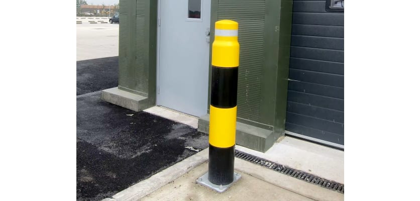 Yellow and Black heavy duty bollard outside a warehouse door