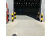 Front View of bollards installed around a warehouse loading door