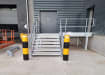 Black and yellow potted bollards installed near stairs