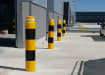 A row of potted bollards installed outside a warehouse