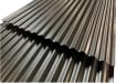 Close up of two corrugated metal sheets overlapping each other 
