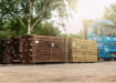 Pallets of Green and Brown Treated Sleepers