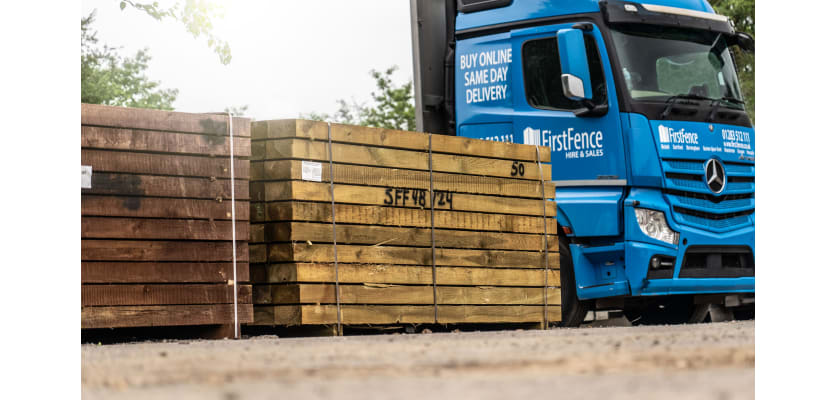 Pallets of Green and Brown Treated Sleepers