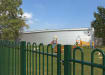 EnviroRail® Green Bow Top Single Leaf Gate Kit installed in play ground  