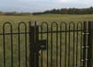EnviroRail® Black Bow Top Single Leaf Gate Kit installed in field 