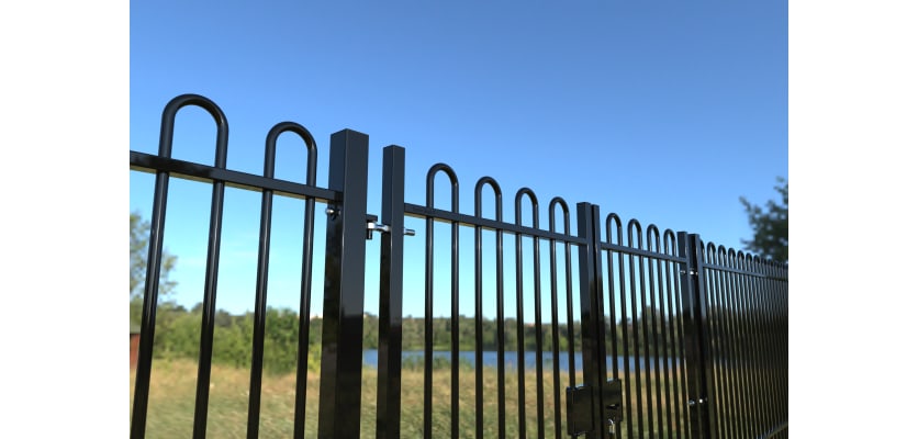Top section of a Black EnviroRail® Bow Top double leaf gate installed at a park