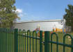 EnviroRail® Bow Top Railing Gate in Green installed at a play area