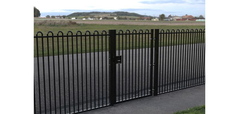 A Black Single Leaf EnviroRail® PlaySec Railing Gate securing a park 