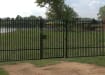 A Black Single Leaf EnviroRail® PlaySec Railing Gate securing a nature reserve