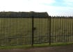 A Black Single Leaf EnviroRail® PlaySec Railing Gate securing a park 