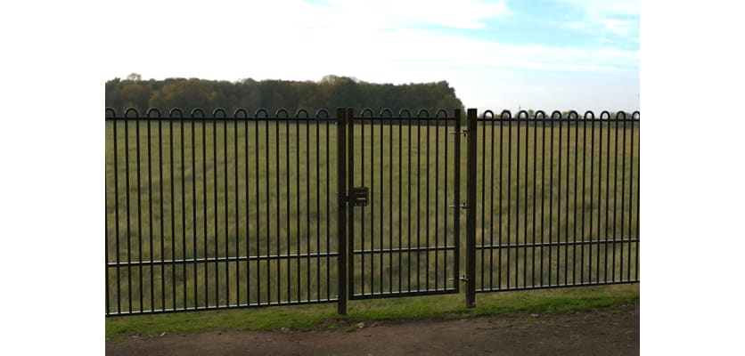 A Black Single Leaf EnviroRail® PlaySec Railing Gate securing a park 