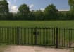 A Black Double Leaf EnviroRail® PlaySec Railing Gate securing a park 
