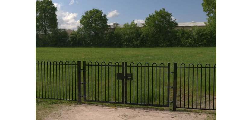 A Black Double Leaf EnviroRail® PlaySec Railing Gate securing a park 