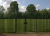 A Black Double Leaf EnviroRail® PlaySec Railing Gate securing a park