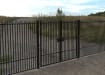 A Black Double Leaf EnviroRail® PlaySec Railing Gate securing a private road 
