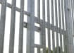 Close up of the sliding latch section of the PaliFence® Palisade Gate installed outdoors 