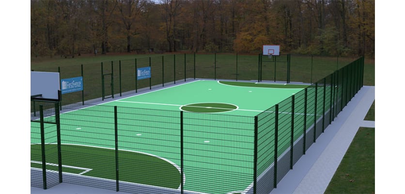 MUGAPlay® Secure 38 Rebound MUGA Kit, with rebound fencing and basketball hoop, installed in a park