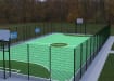MUGAPlay® Secure 38 Rebound MUGA Kit, with rebound fencing and basketball hoop, installed in a park