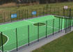 MUGAPlay® Secure 38 Rebound MUGA Kit positioned on a grass field