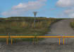 Yellow Steel Knee Railings in front of a grassy area