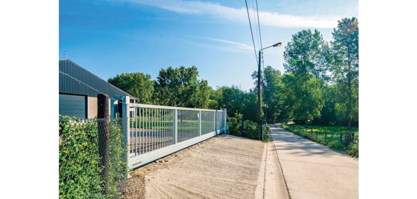 A white FFL 130 Automated Gate outside an industrial unit 