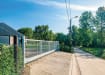 A white FFL 130 Automated Gate outside an industrial unit 