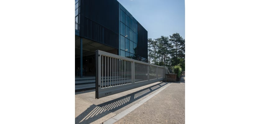 A grey FFL 95 Manual Cantilever Gate Outside an Office Building 
