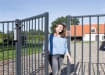 A Person using a Gate with a Hydraulic Gate Closer attached 