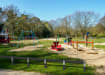 Black Plastic Composite Knee Rail Fencing around a childrens play area