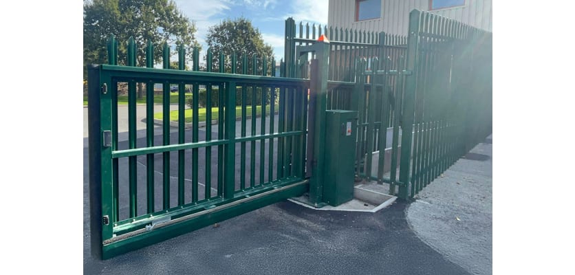 A FFL 130 Manual Palisade Cantilever Gate in Green outside of an Industrial Unit 