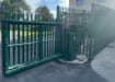 A FFL 130 Manual Palisade Cantilever Gate in Green outside of an Industrial Unit 